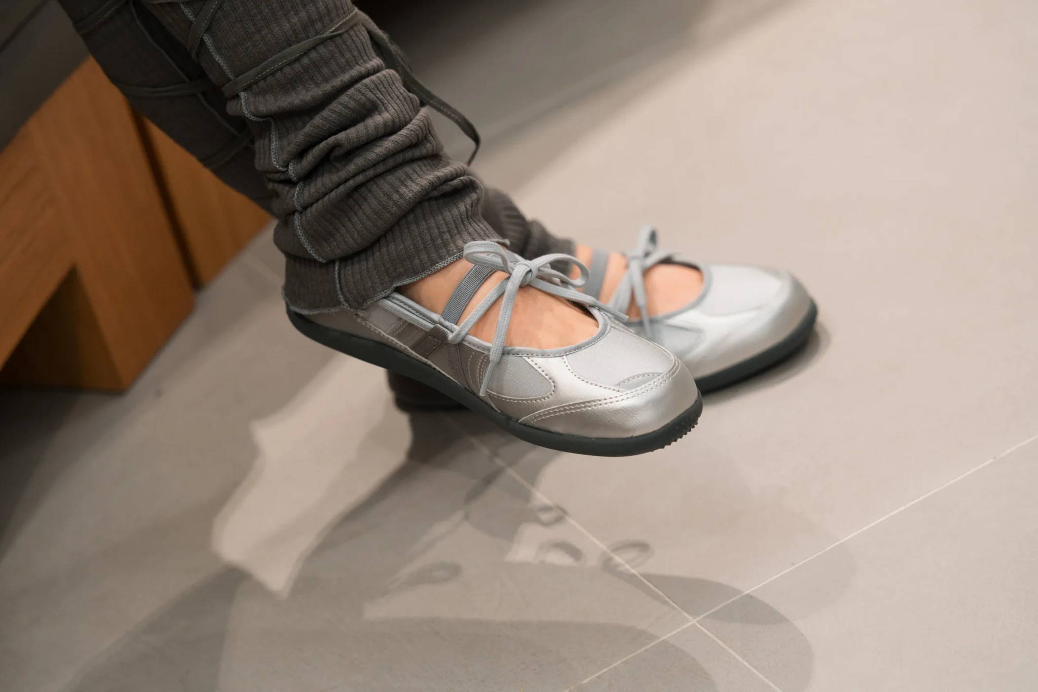 The silver New Balance Flat Breeze worn on foot