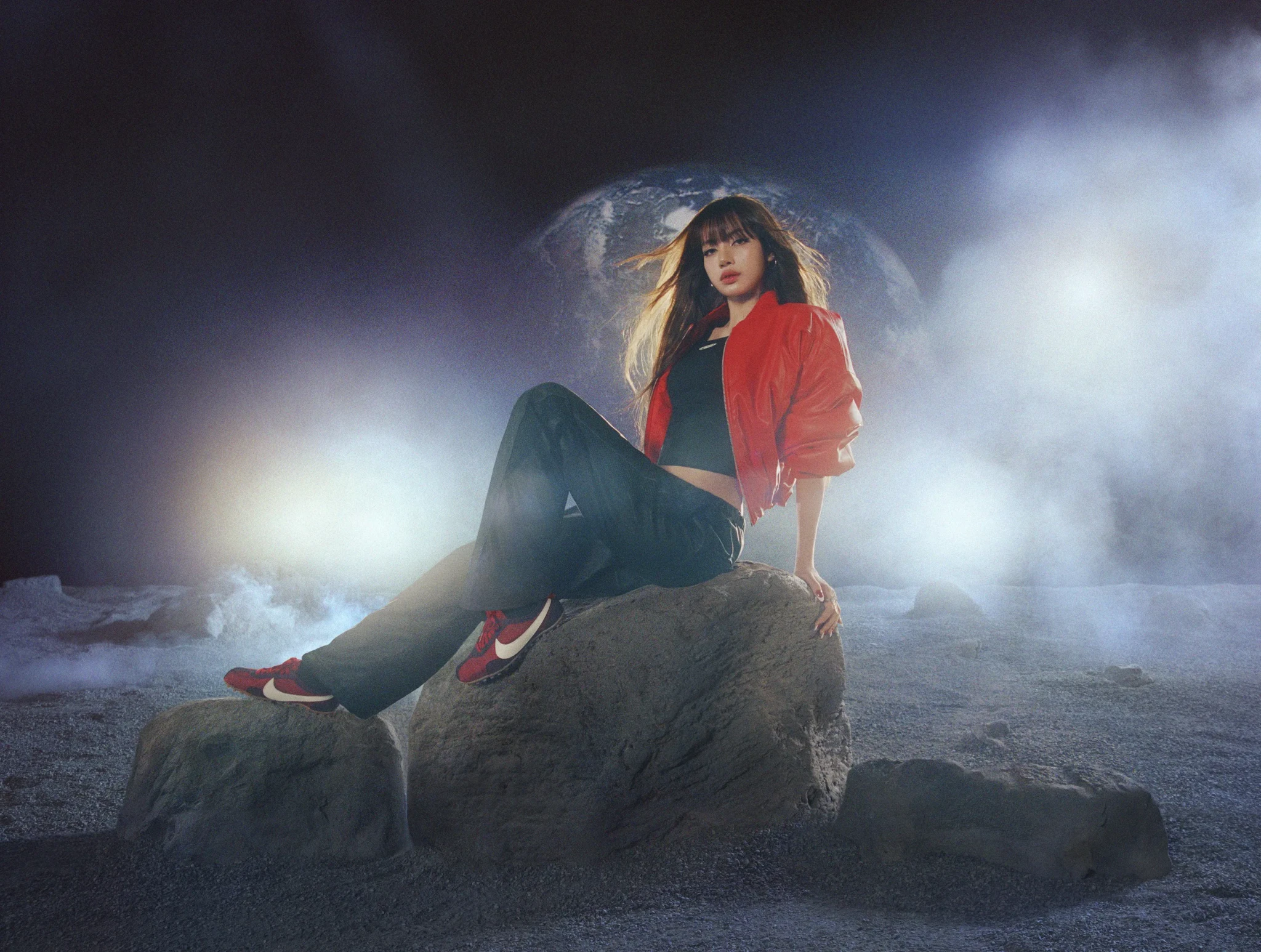 LISA seated on a rock in a misty moonlike landscape with Earth rising behind her