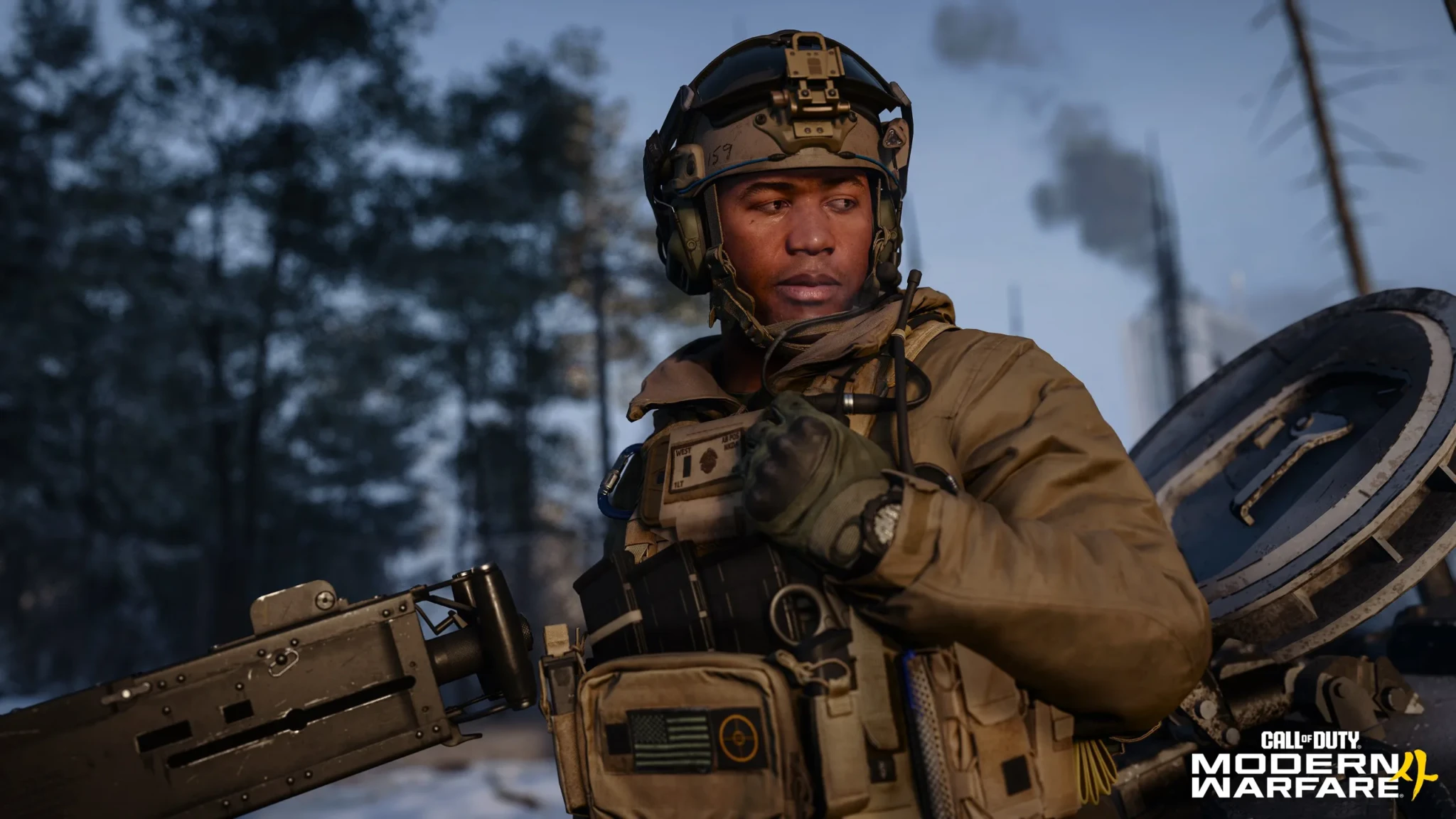 A soldier with a night-vision mount on his helmet stands beside a mounted machine gun in a snowy forest in Call of Duty: Modern Warfare 4