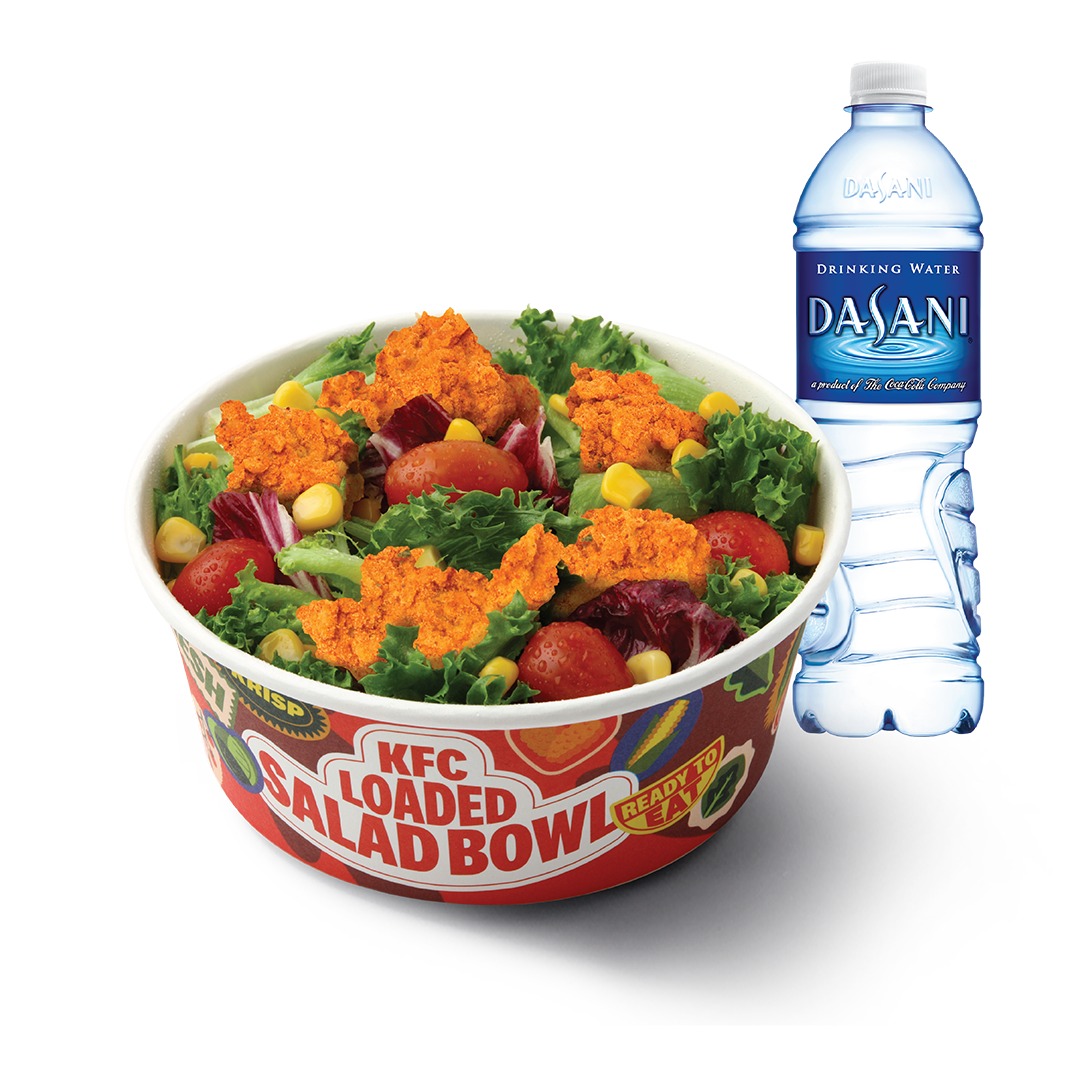 KFC Louisiana Loaded Salad Bowl Meal with chicken, corn and cherry tomatoes beside a bottle of Dasani water