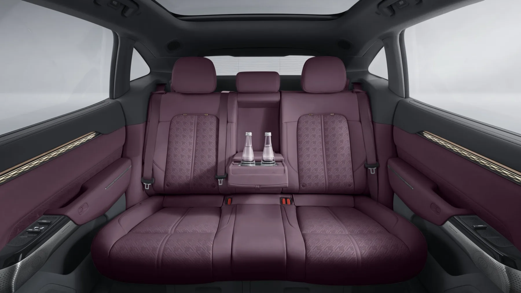 The rear seat of a Zeekr 7X in purple leather with two water bottles in the centre armrest