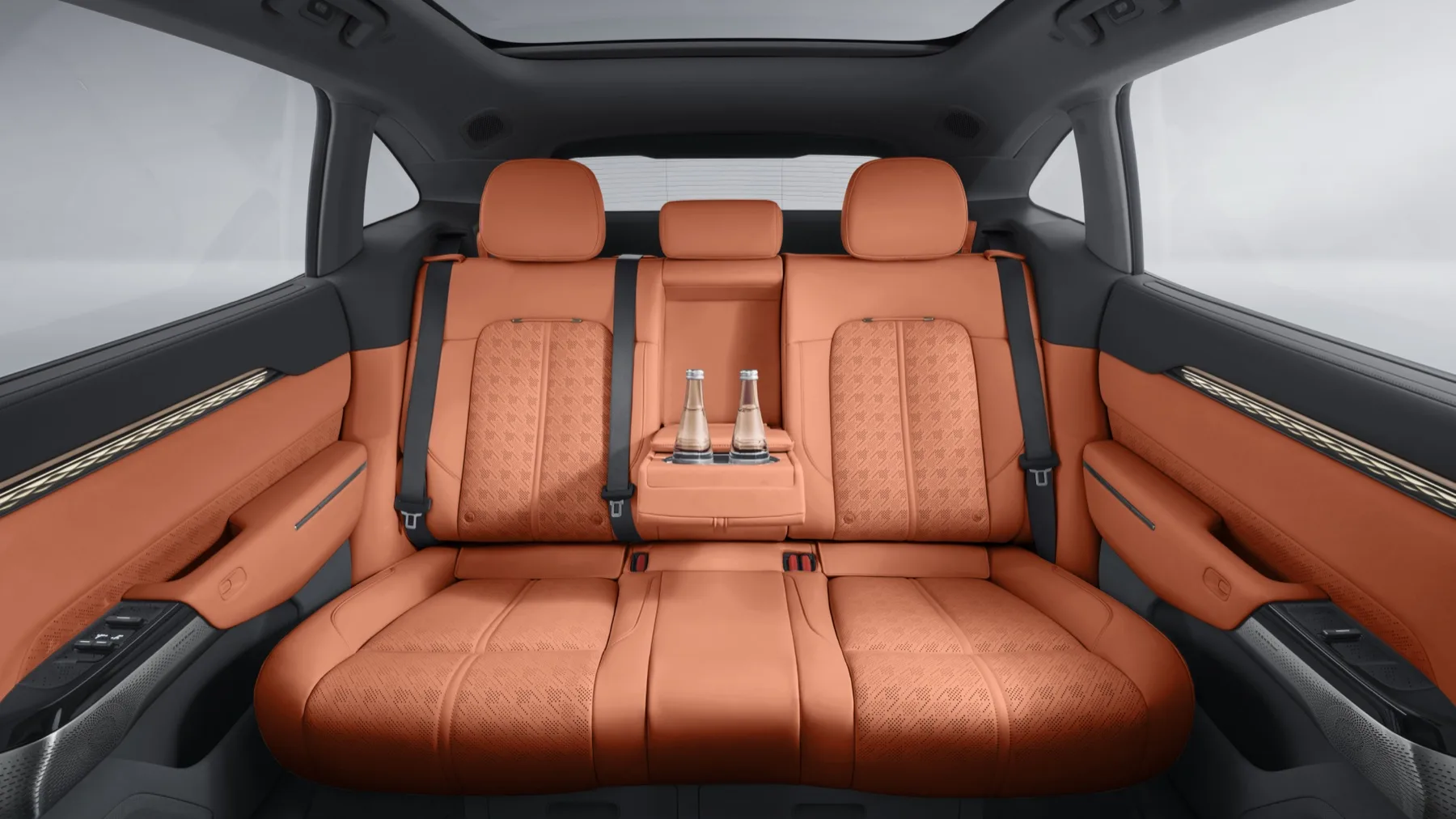 The rear seat of a Zeekr 7X in orange and black leather