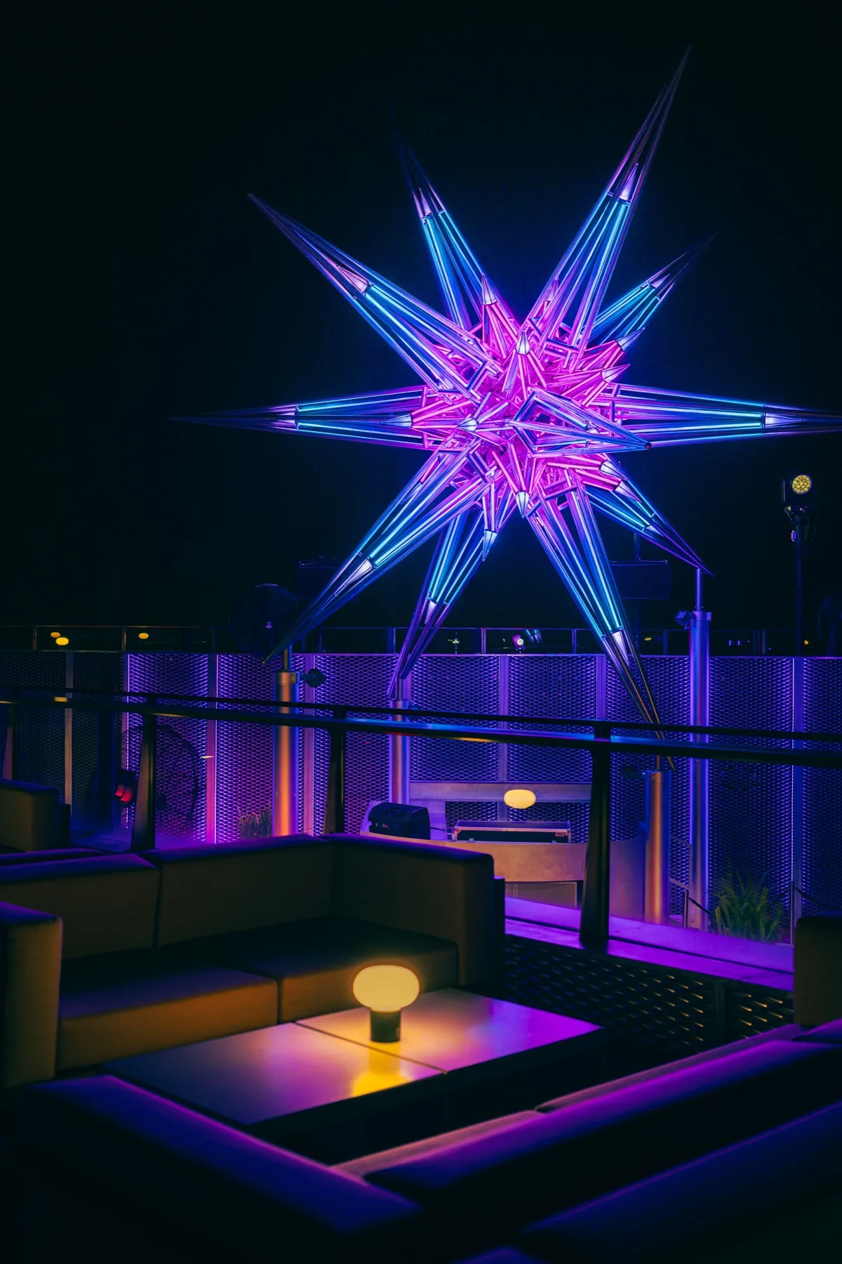 NOVA's star sculpture lit at night over the rooftop bar