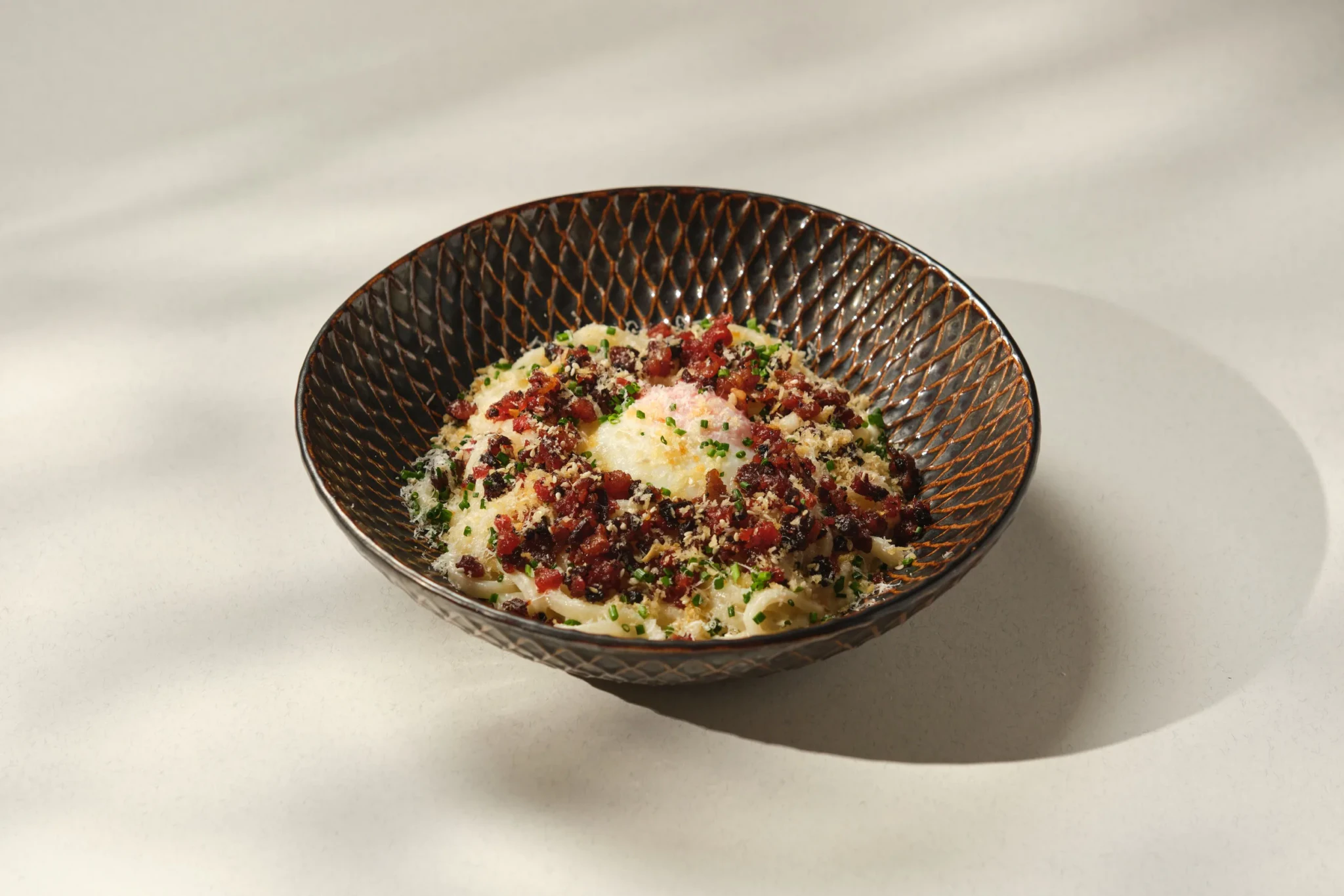 Lap Cheong Carbonara at PS.Cafe Harding, topped with a soft-cooked egg, crispy lap cheong bits, grated cheese and chives
