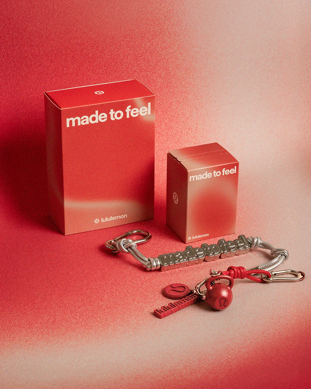 lululemon made to feel packaging with silver keychain charms and red kettlebell and logo accents
