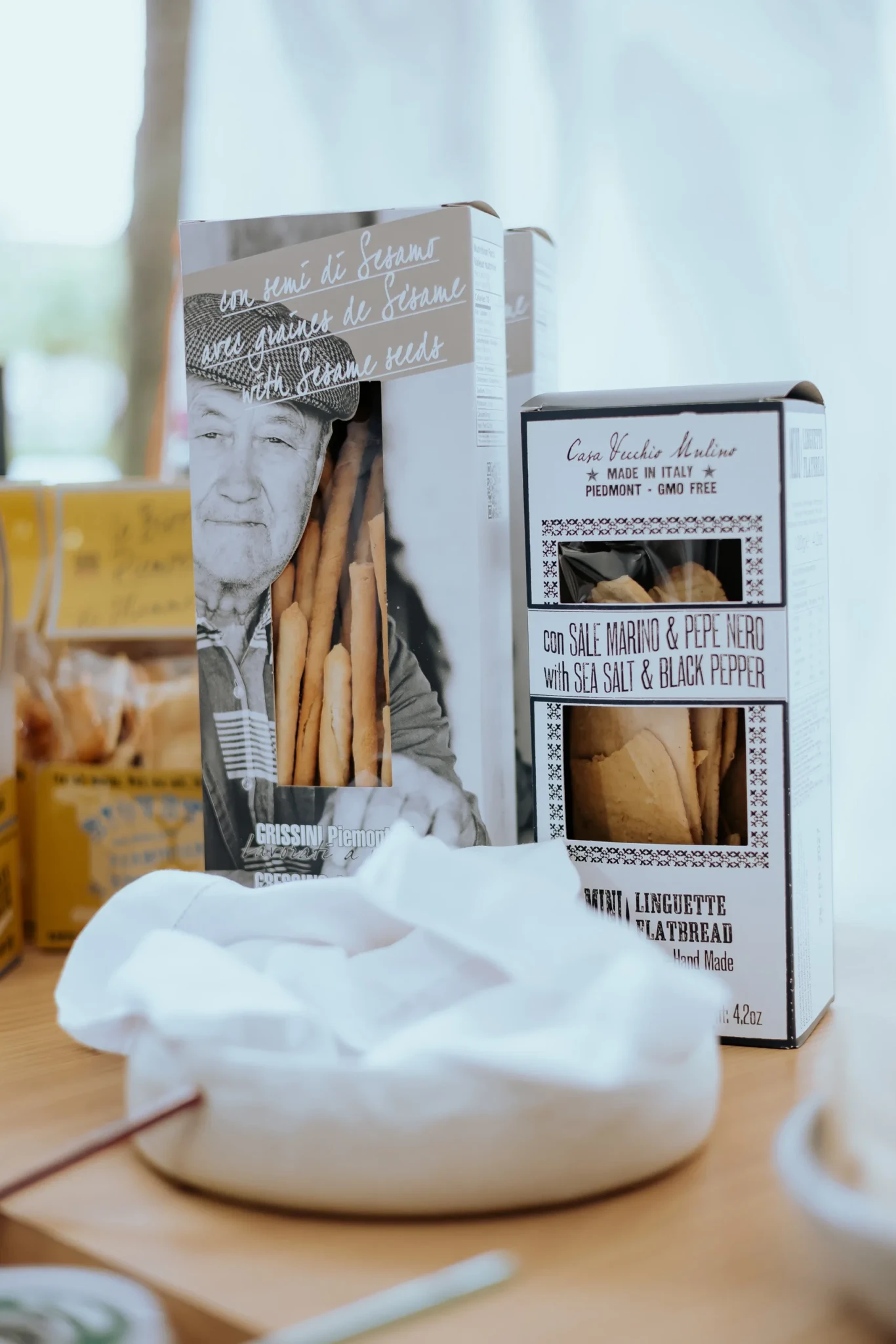 Packaged Casa Vecchio Mulino Piedmont grissini breadsticks and mini linguette flatbread on a wooden table