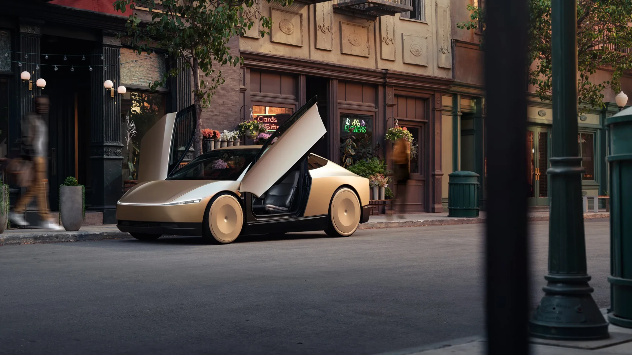 Tesla Cybercab with its doors raised on a city street.