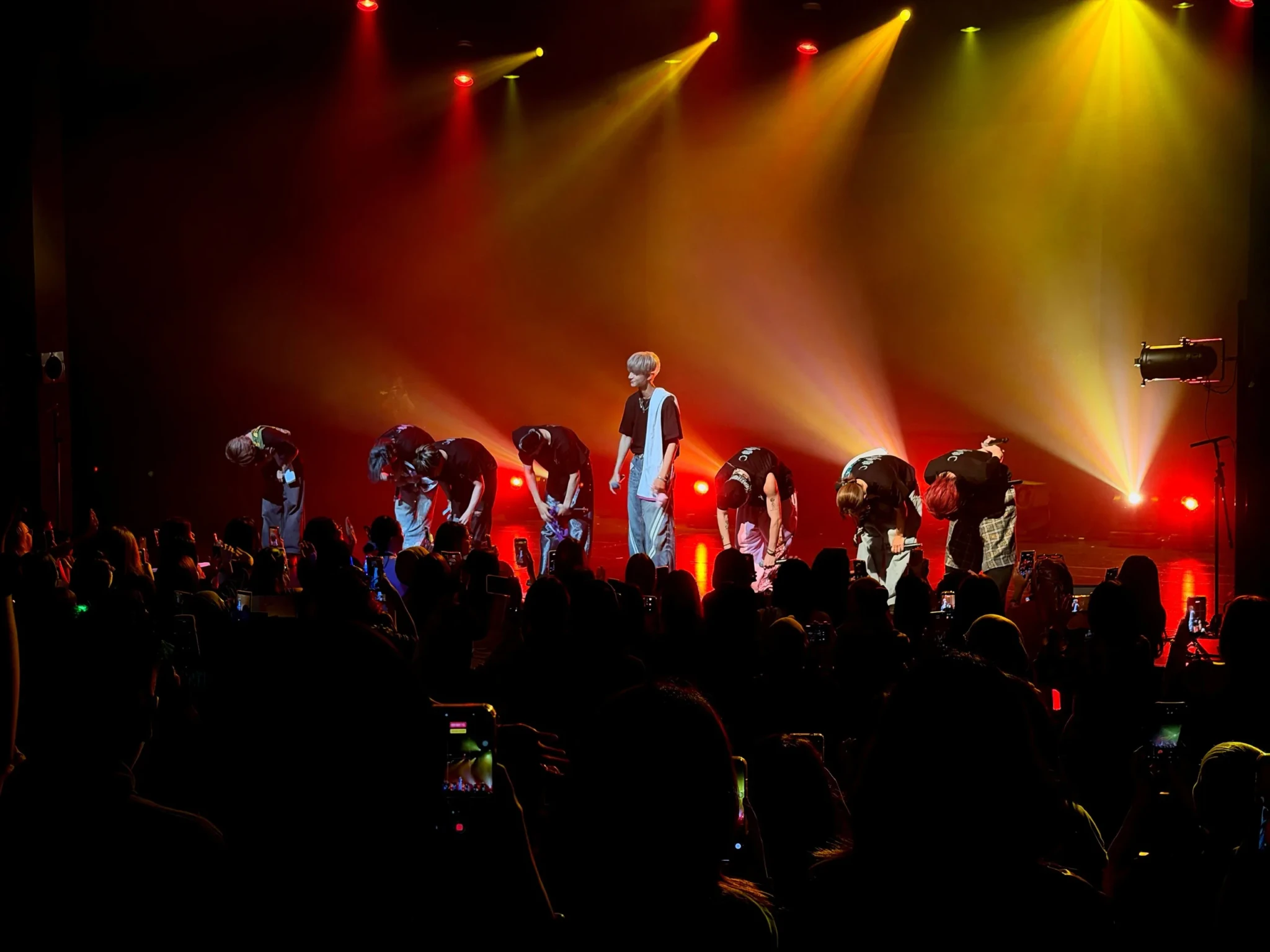 ONE OR EIGHT bow to the crowd beneath red and yellow stage lights at the end of their Singapore show