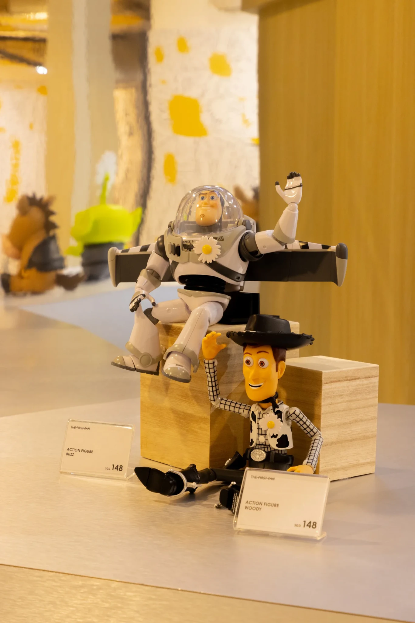 Buzz Lightyear and Woody action figures on display at the pop-up