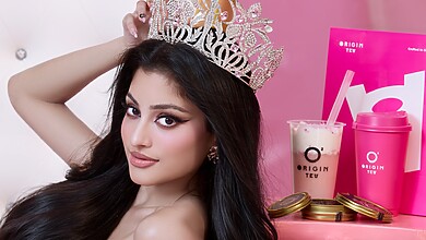 Riona Dighe in a crown beside Origin Tea's Riri's Pink Crown drink and caviar tins