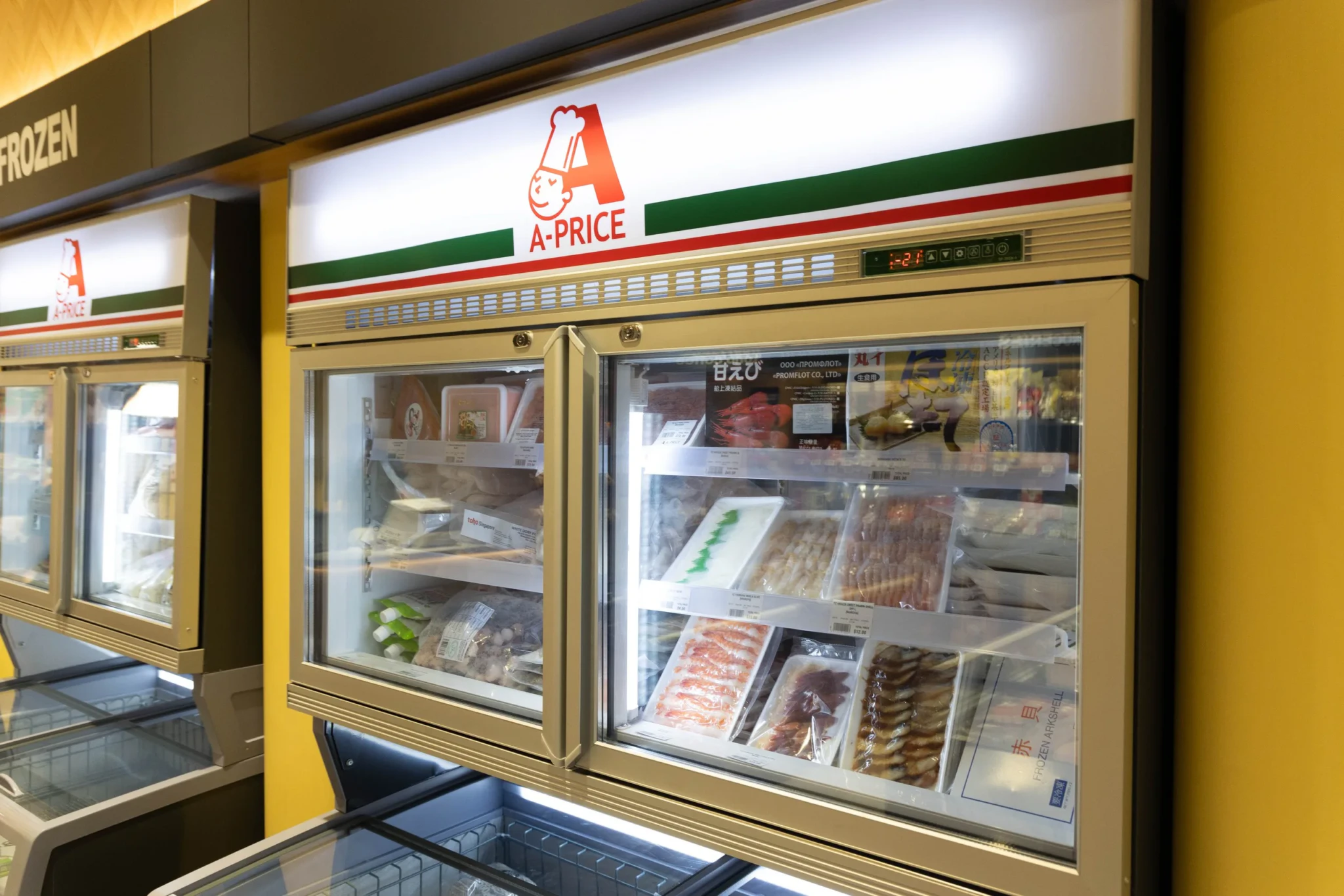 A-PRICE's frozen seafood cabinets stocked with packaged Japanese ingredients, including shrimp and arkshell clams