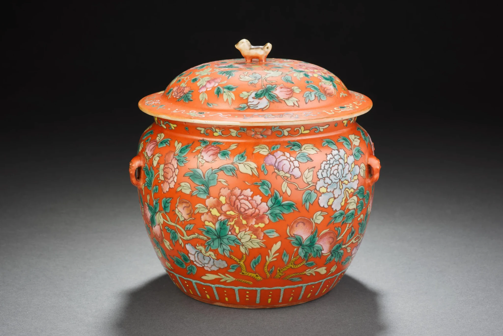 A red-ground famille-rose kamcheng with floral decoration and a bird-shaped finial from the Peranakan Museum's collection