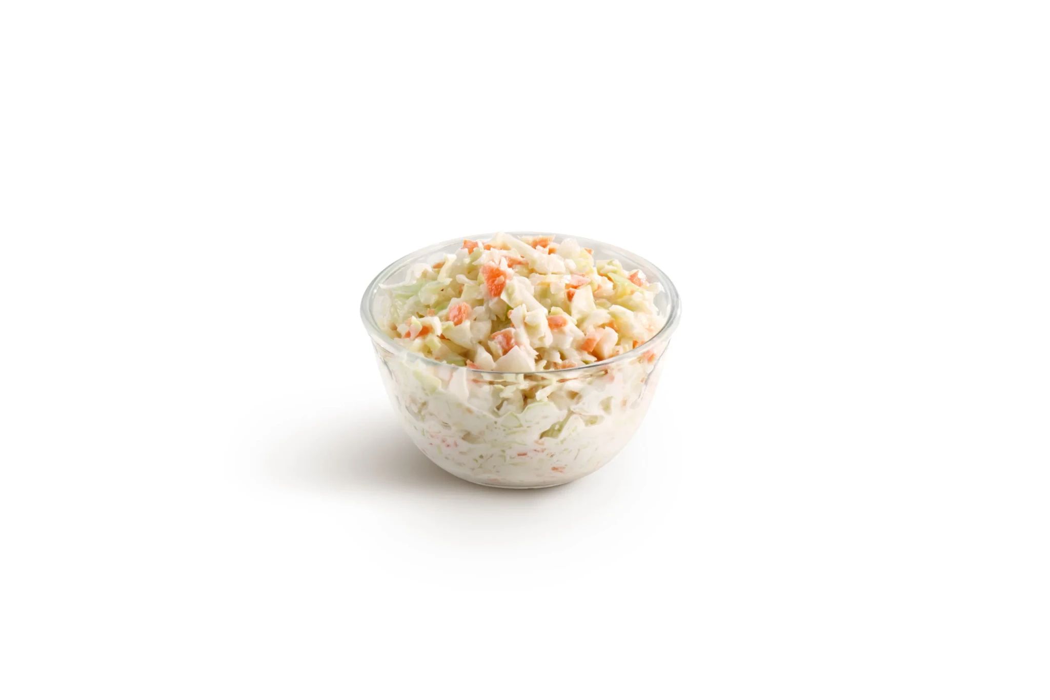 A glass bowl of creamy coleslaw with shredded cabbage and carrot