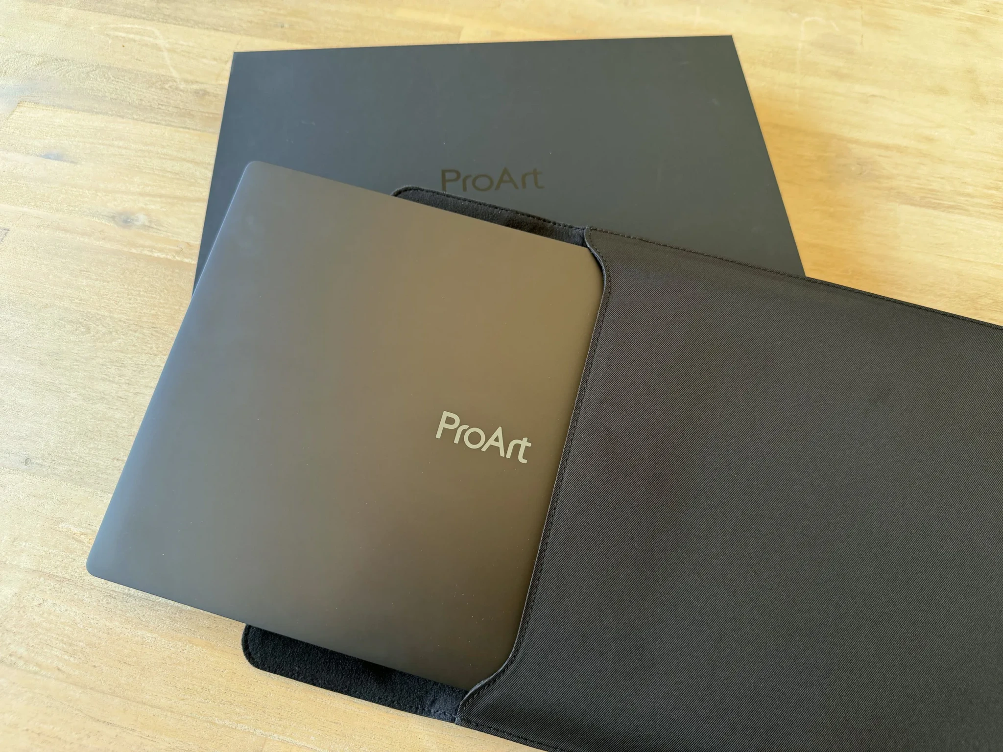 The ProArt P16 being slid into its included protective sleeve