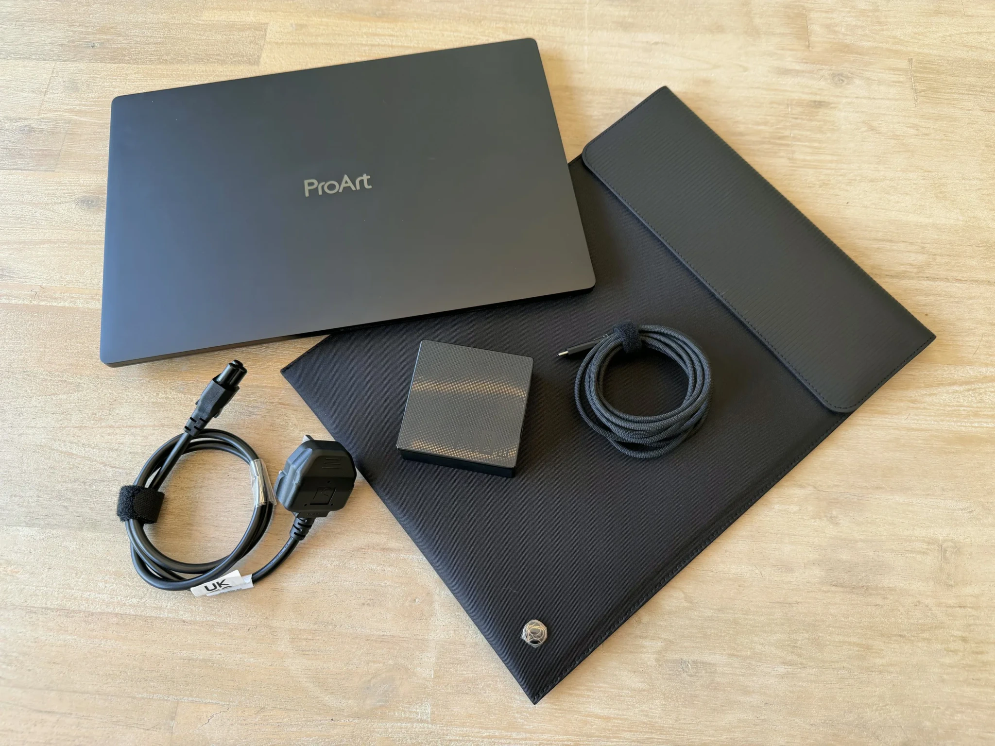 The ProArt P16 box contents laid out: laptop, sleeve, charger, USB-C cable and power cord