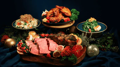 Waa Cow! Christmas Bundle C with Wagyu striploin, roasted chicken, potato salad and spinach on a dark navy cloth
