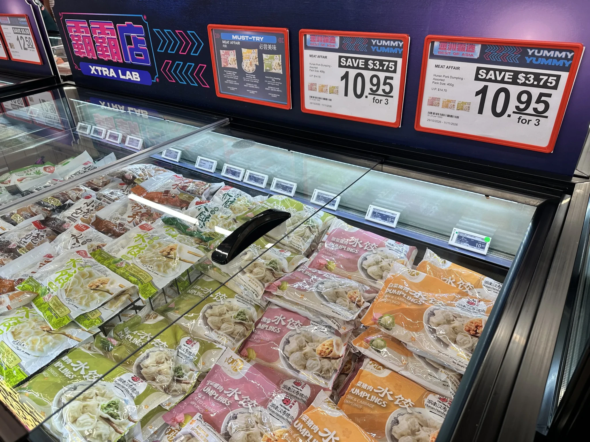 Frozen Meat Affair Hunan pork dumplings in a freezer case at Xtra Lab with a 3 for $10.95 price tag