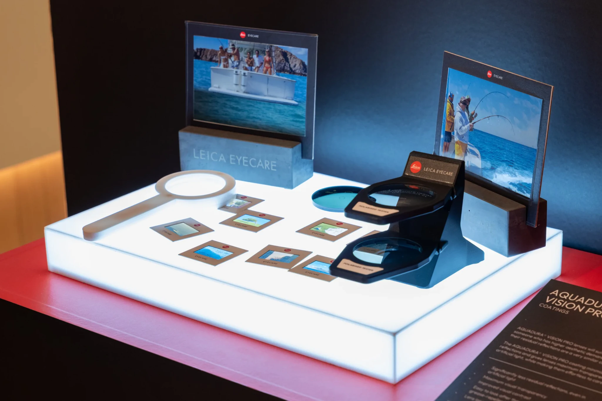 Leica Eyecare display at its Singapore debut, featuring polarised lens testers, a magnifier and framed lifestyle photos of people boating and fishing on the wat