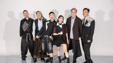 The six members of vocal band MICappella posing together in stylish black and layered outfits against a plain white backdrop, promoting Sing On 2026: It's A Wra