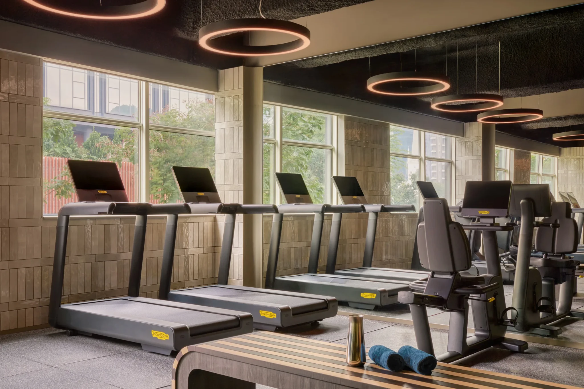 Technogym treadmills and a recumbent exercise bike in the 24-hour gym at APT. at Stamford Place, Singapore.